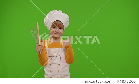 Child girl kid cook chef baker posing, smiling, showing thumb up on green chroma key background 74873266