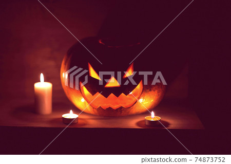 candles and pumpkin for Halloween in a cramped room 74873752