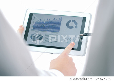 businessman pointing with pen on a digital tablet screen. 74873780