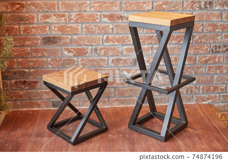 two stylish chairs on a brick wall background two stylish chairs on a brick wall background 74874196