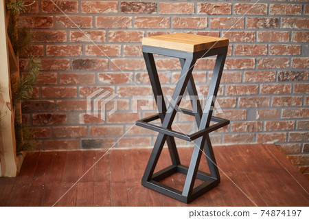 stylish bar stool on brick wall background. stylish bar stool on brick wall background. 74874197