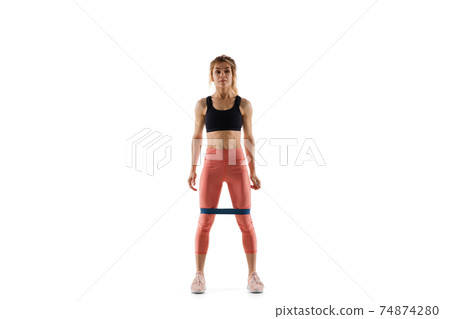 Young caucasian female model in action, motion isolated on white background. Concept of sport, movement, energy and dynamic, healthy lifestyle. Training, practicing. 74874280