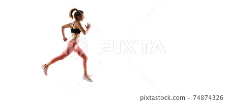 Young caucasian female model in action, motion isolated on white background. Concept of sport, movement, energy and dynamic, healthy lifestyle. Training, practicing. 74874326