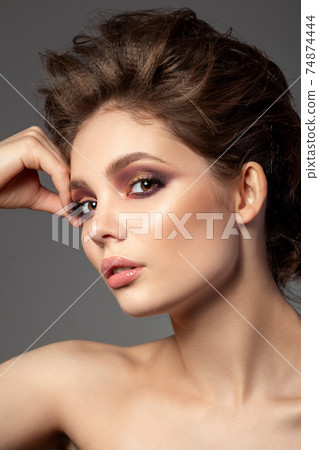 Portrait of beautiful woman with evening makeup Portrait of beautiful woman with evening makeup 74874444