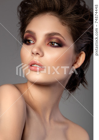 Portrait of beautiful woman with evening makeup Portrait of beautiful woman with evening makeup 74874448