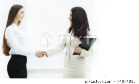 blurred image for the advertising text. photo with copy space. successful business woman shaking hands with employee 74874885