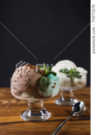Ice-cream scoops variety in glass sundae bowls 74875876