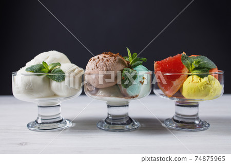 Set of ice cream scoops in glass sundae bowls Set of ice cream scoops in glass sundae bowls 74875965