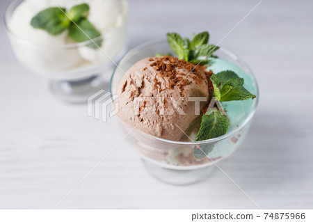 Ice-cream scoops variety in glass sundae bowls 74875966
