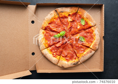 Pepperoni pizza in carton box Pepperoni pizza in carton box 74876010