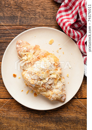 Almond croissant on a plate Almond croissant on a plate 74876011