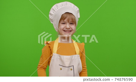 Charming child girl dressed like chef cook laughing out loud after hearing ridiculous anecdote 74876590