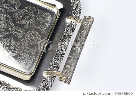 Antique silver tray with handles. Old luxury tray isolated on white background with copy space. Closeup 74876690