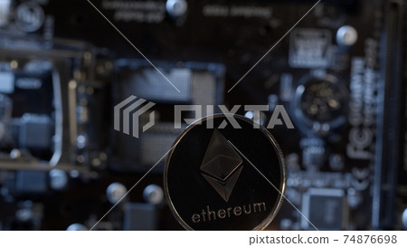 Ethereum coin on digital technology pc motherboard background, cryptocurrency money mining 74876698