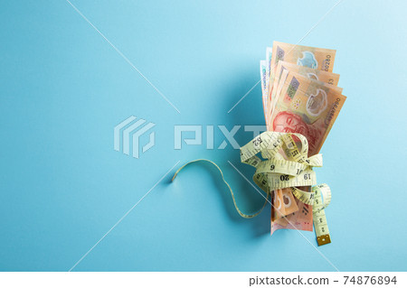 Money with a tape measure. Price growth. Inflation Concept. Money with a tape measure. Price growth. Inflation Concept. 74876894