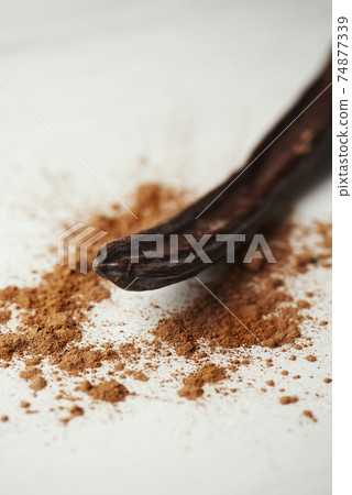 ripe carob pod and carob powder on a table ripe carob pod and carob powder on a table 74877339