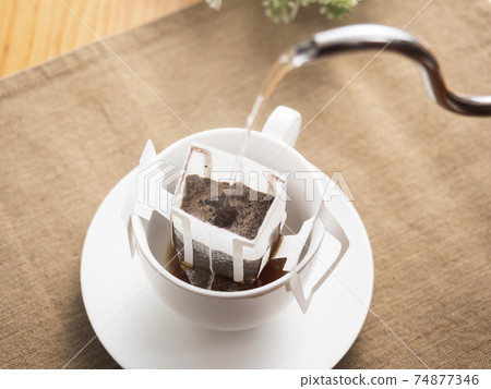 Brewing hot coffee with a drip bag for cups Brewing hot coffee with a drip bag for cups 74877346