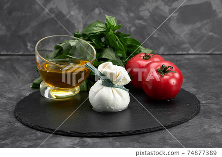 Cheese collection, fresh soft white burrata cheese ball made from mozzarella and cream from Apulia, Italy, close up Cheese collection, fresh soft white burrata cheese ball made from mozzarella and cream from Apulia, Italy, close up 74877389