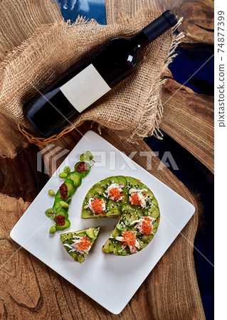 Salad of avokado, seafood, meat, vegetables and pumpkin seeds. Dietary, wholesome and tasty. Banquet festive dishes. Gourmet restaurant menu. White background. 74877399