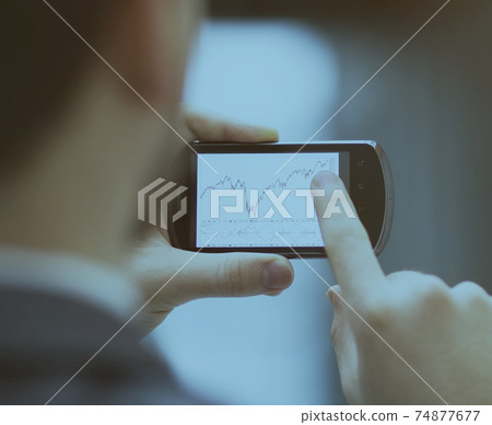 Modern people doing business, graphs and charts being demonstrated the screen of a phone 74877677