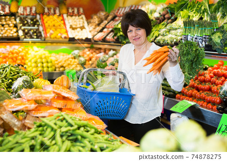 Adult female taking vegetables Adult female taking vegetables 74878275