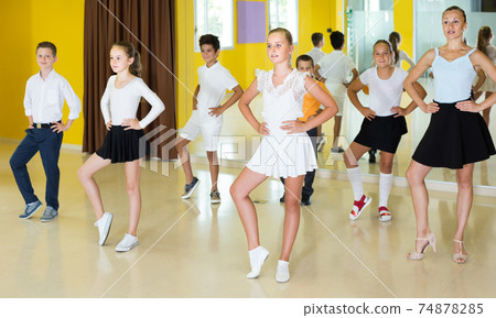 Children learn dance movements in dance class 74878285