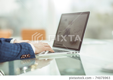 successful businessman working on laptop in the workplace. 74878963