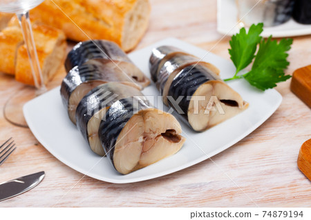 Closeup slices of slightly salted herring with parsley Closeup slices of slightly salted herring with parsley 74879194