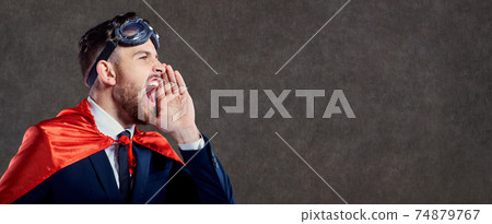 A businessman in a superhero costume calls screams. 74879767