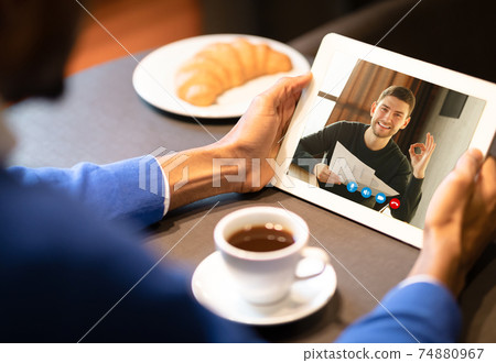 Two Men Having Online Video Call On Tablet Two Men Having Online Video Call On Tablet 74880967