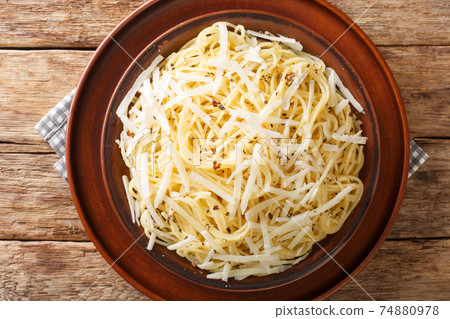 Roman pasta with black pepper and cheese close-up in a plate. horizontal top view Roman pasta with black pepper and cheese close-up in a plate. horizontal top view 74880978