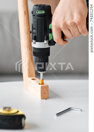 Repairman, carpenter, man assembles, repairs or makes furniture concentrated 74881294