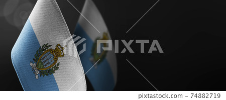 Small national flags of the San Marino on a dark background Small national flags of the San Marino on a dark background 74882719