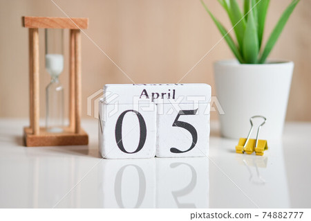 Date on white wooden cubes - the fifth, 05 April on a white table. 74882777
