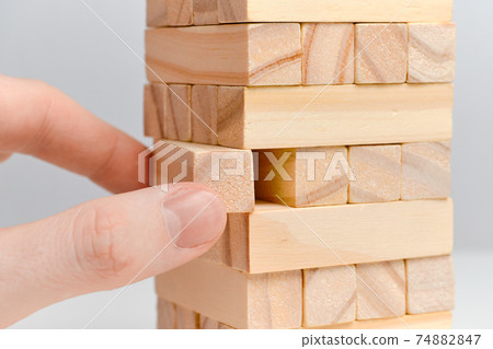 Big date moderation concept. Hand holds wooden blocks on a white background. Big date moderation concept. Hand holds wooden blocks on a white background. 74882847
