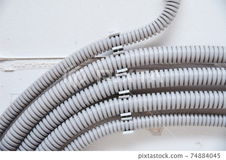 Electric cable corrugated on ceiling. Cable laying ceiling 74884045