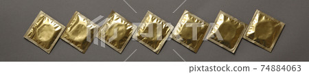 Blank condoms on gray background, top view 74884063