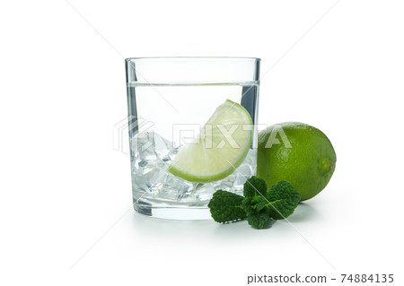 Glass of vodka with lime and ice isolated on white background 74884135