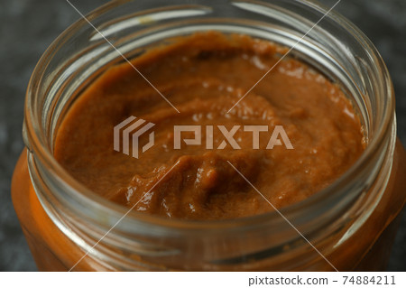 Glass jar with squash caviar, close up 74884211