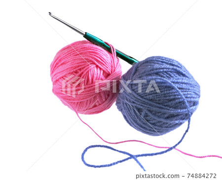 Crochet hook and Ball of wool yarn. Crochet hook and Ball of wool yarn. 74884272