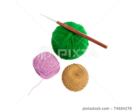 Crochet hook and Ball of wool yarn. 74884276