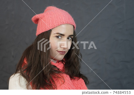 Portrait of a girl, natural look, with long hair in a pink knitted hat Portrait of a girl, natural look, with long hair in a pink knitted hat 74884553