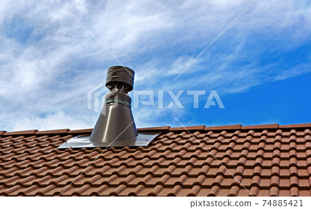 Chimney pipe on the tile roof. Chimney pipe on the tile roof. 74885421