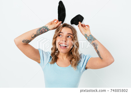 Portrait young beautiful woman wearing easter bunny ears Portrait young beautiful woman wearing easter bunny ears 74885802