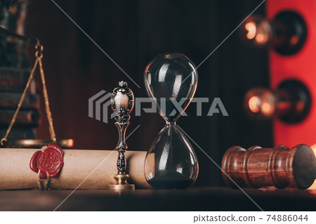 Wooden gavel, hourglass and antique stamp with last will on wooden table. Wooden gavel, hourglass and antique stamp with last will on wooden table. 74886044