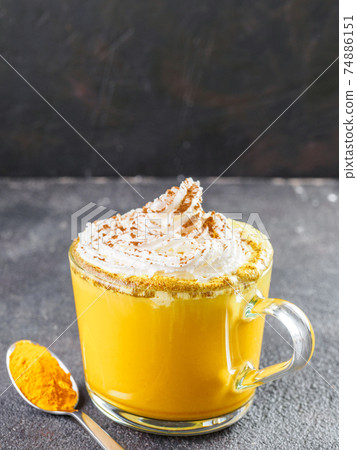 golden turmeric latte and ingredients, copy space 74886151