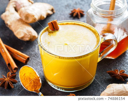 golden turmeric latte and ingredients, copy space 74886154