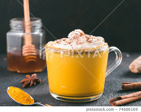 golden turmeric latte and ingredients, copy space 74886169