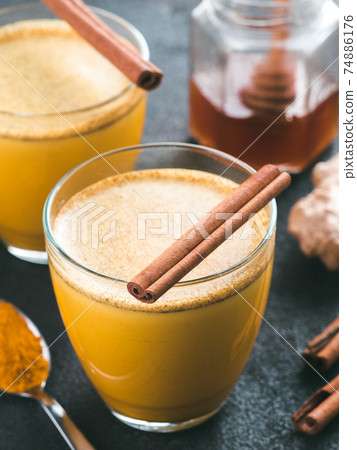 golden turmeric latte and ingredients, copy space golden turmeric latte and ingredients, copy space 74886176