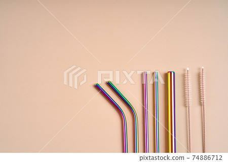 The modern trend in environmental care. Reusable metal straws for drinks. Replacement with common plastic beverage straws 74886712